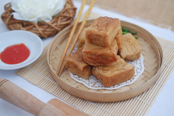 Golden Fried Tofu Crispy Cubes on a Bamboo Plate