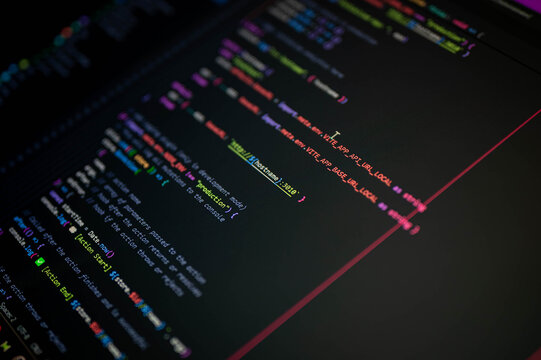 Close-up of colorful programming code on screen showing production environment setup with console.log, symbolizing frontend development, API configuration, and digital technology.