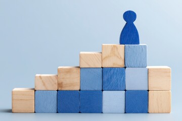 Wooden blocks form a stairway, with a blue figure at the top