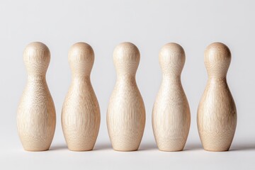Five light-brown wooden bowling pins in a row
