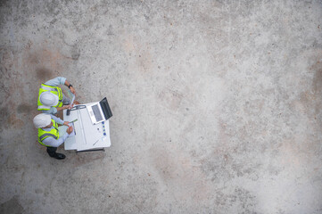 Top view of expert engineers planning and drafting the building structure to suit its intended use.