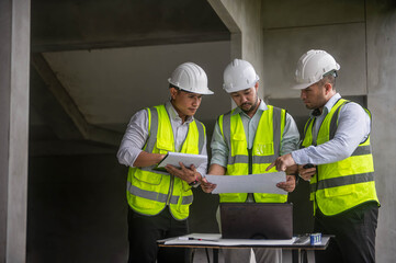 Expert engineers are brainstorming together to design the structure of an office building.