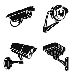 Collection of four black security surveillance cameras in different styles mounted on walls for monitoring and protection