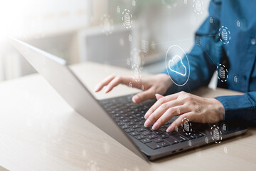 Close-up of hands typing on laptop with floating cloud computing icons, concept of cloud storage, data backup, big data, digital transformation, and online technology services.