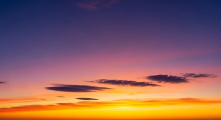 Fototapeta premium Colorful Sunset Sky with a Gradient from Orange to Purple and Silhouetted Clouds.
