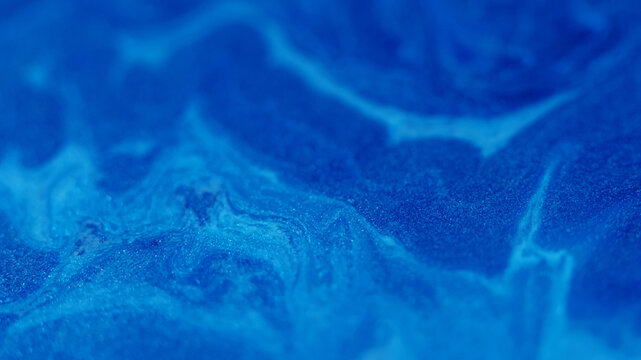 Shimmer mix. Acrylic enamel. Defocused blue color marble paint water fluid texture floating on abstract art wet creative background.