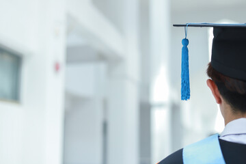 Back view of graduates celebrating their college graduation with pride and joy on graduation day. Congratulations.