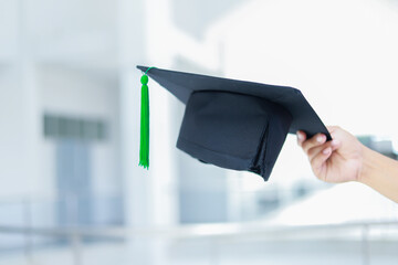 Back view of graduates celebrating their college graduation with pride and joy on graduation day. Congratulations.