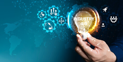 Hand holding glowing light bulb with Industry 4.0 digital icons and world map concept of smart technology
