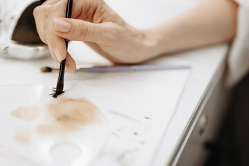 Makeup artist hand with brush applying makeup