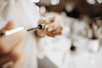 Mascara. Makeup artist takes out brush with mascara. Makeup concept, close-up