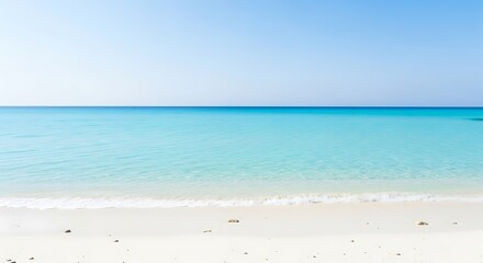 Idyllic white sand beach with crystal-clear turquoise ocean water under a serene blue sky, tropical paradise