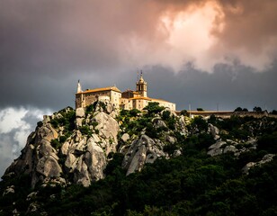 Obraz premium Dramatic mountaintop monastery at sunset