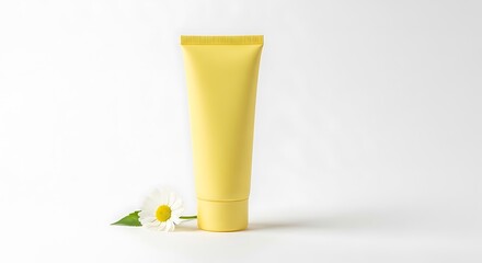 Vibrant Yellow Cosmetic Tube Mockup with White Daisy Flower on Clean White Background for Skincare Promotion