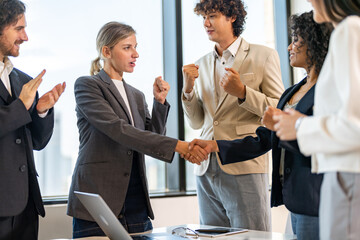 Multiracial team collaborating in modern office, diverse colleagues shaking hands during a business meeting, teamwork success, partnership agreement, professional collaboration multicultural workplace