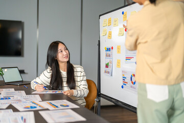 Asian businesswoman startup presenting data chart project management meeting with colleagues, financial report analysis teamwork strategy plan corporate success at office, marketing, data analytics