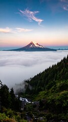 Naklejka premium Mountain peak rising above a sea of clouds