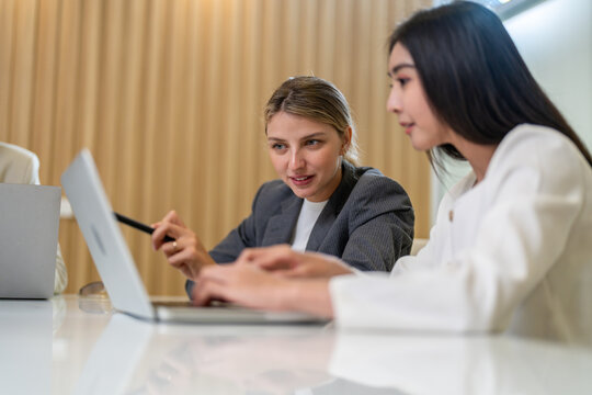 Diverse tech team meeting on software project, mentor guiding coworker on laptop, teamwork development using collaboration tools, modern technology, app design, dev training and enterprise SaaS team