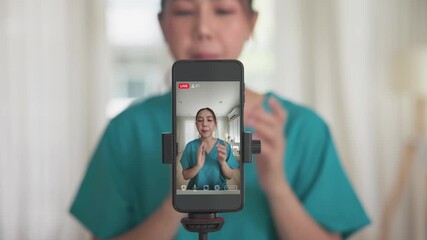 Young adult woman asia Gen Z people anti aging expert modern nurse live talk viral video selfie camera on mobile phone app mental health care. Online sharing digital virtual asian vlogger filming. - Powered by Adobe