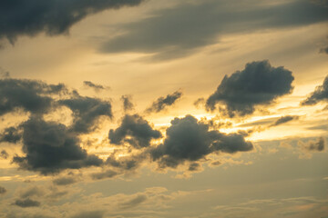 Dramatic clouds fill a golden sky.