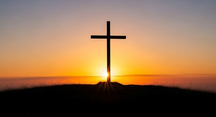 Silhouette of a Christian cross on a hill against a vibrant orange and yellow sunset sky, symbolizing hope