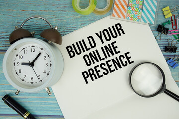 Build Your Online Presence text written on notepad with alarm clock and magnifying glass flat lay...