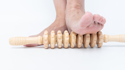 Wooden foot massager tool being used on bare foot, providing relief for swollen legs and enhancing...