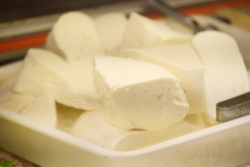 Fresh cheese ready for preparation in a kitchen setting