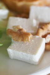 Fresh cheese served with walnuts in a rustic setting