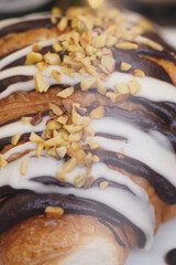 Delicious croissant topped with chocolate and nuts