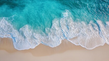 aerial shot of gentle rolling waves meeting pale sand, seafoam patterns winding across crystalline blue water