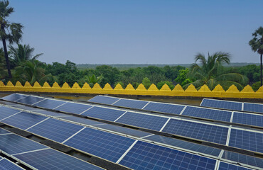 Solar panels system on rooftop on building with tree forest background. 