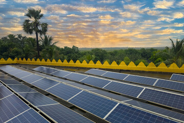 Beautiful view of solar panels with dramatic sky and forest background.