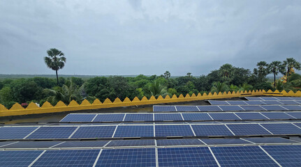 Solar panels system on rooftop on building with tree forest background. 