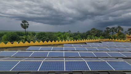 Beautiful view of solar panels with dramatic sky and forest background.