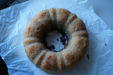 Homemade bundt cake without glaze on parchment paper, rustic autumn dessert with poppy seeds,...