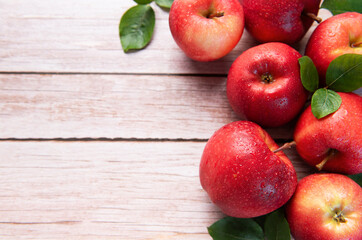 Fresh red apples resting on rustic wooden table