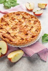 Delicious homemade apple pie decorated with fresh apple slices and leaves