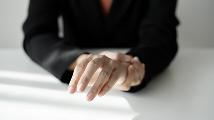 Fototapeta premium Woman hand with wrist pain numbness and pain in the palm of the hand has pain and tingling in the nerve endings This is a side effect of sitting and working for a long time on a laptop at the office