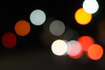 Dreamy night bokeh from cars in traffic, colorful circles of light. Vibrant traffic bokeh with red and yellow lights, soft night focus.