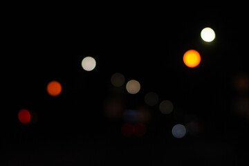 Defocused background of moving cars, abstract urban night bokeh. Dreamy night bokeh from cars in...