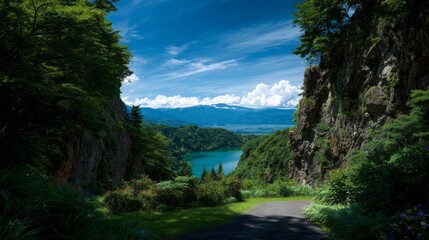 Breathtaking vista of a serene turquoise lake nestled between lush green mountains and rugged cliffs under a vibrant blue sky with wispy clouds, an idyllic natural paradise.