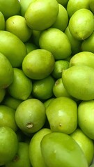 Green Jujube Pile: A vibrant, close-up capture of a luscious pile of fresh, green jujubes, showcasing their natural shapes and enticing textures.
