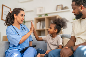 Obraz premium African girl high five with doctor after recovery, happy child leaving hospital healthy, pediatric care success, flu treatment completed, positive experience in children hospital, health insurance