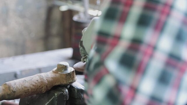 Back View Construction Industrial Factory or Metalwork Concept by Mechanic or Technician Using Grinder with Ball Joint Auto Part