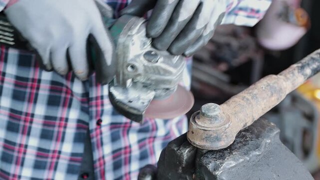 Front View Construction Industrial Factory or Metalwork Concept by Mechanic or Technician Using Grinder with Auto Part Workshop
