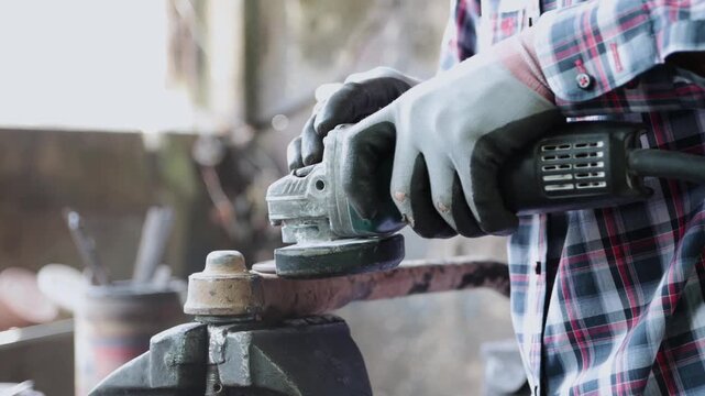 Construction Industrial Factory or Metalwork Concept by Mechanic or Technician Using Grinder with Auto Part Workshop