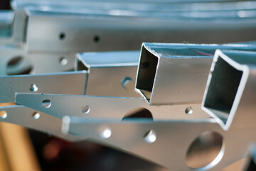 The metal profile is clean, rust-free. Fasteners of the prefabricated structure of an industrial greenhouse. assembly flanges with bolt holes. High quality photo