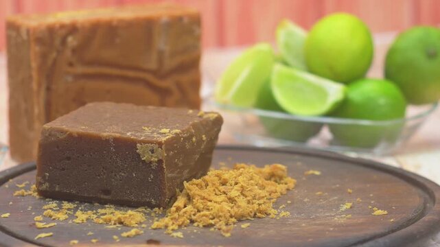 close-up of raw panela on a rustic wooden board, a traditional and sweet unrefined cane sugar block