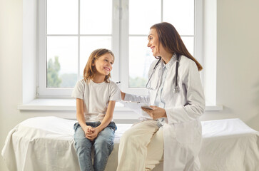 Pediatrician kind smiling doctor talking listening to kid, child health care, clinic checking up exam, kid patient sitting on coach, healthcare hospital professional controlling physical well-being